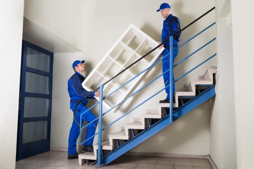 Moving team loading items safely with protective handling equipment