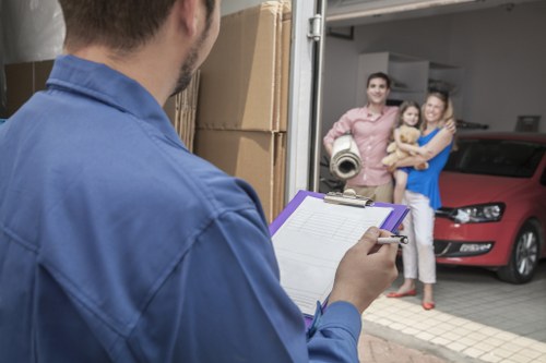 Trained movers carrying furniture with care during a relocation