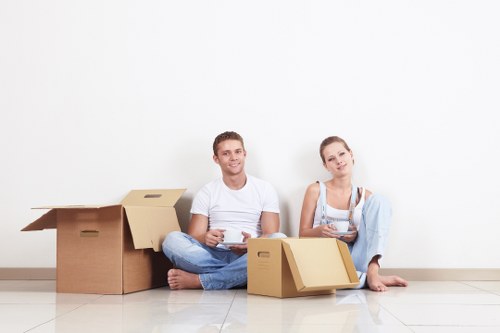Removal team handling furniture and boxes in a South Kensington property