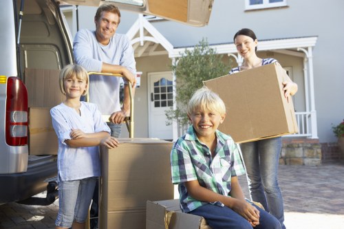 Professional movers handling boxes in a South Kensington apartment building