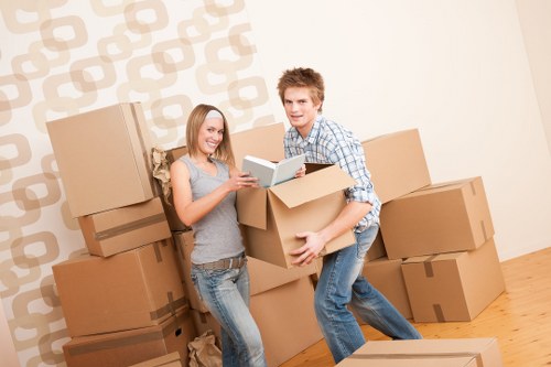 Careful loading of household items by a man with van team
